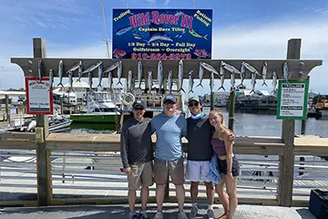 Young boy holding a Spanish mackerel on a Half Day inshore trip from Carolina Beach