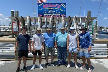 Anglers with Amberjacks after a live bait fishing trip off Carolina Beach
